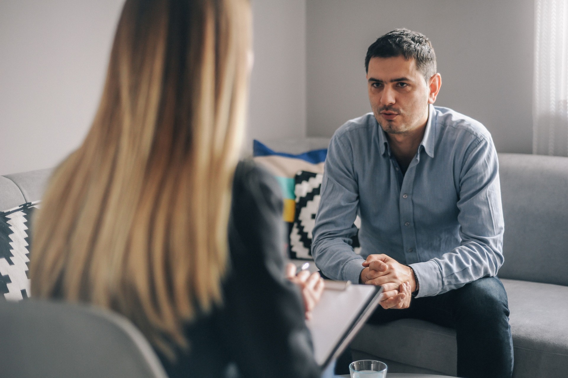 Young man having a home meeting with counsellor